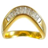 A high purity gold diamond set eleven stone wishbone ring.