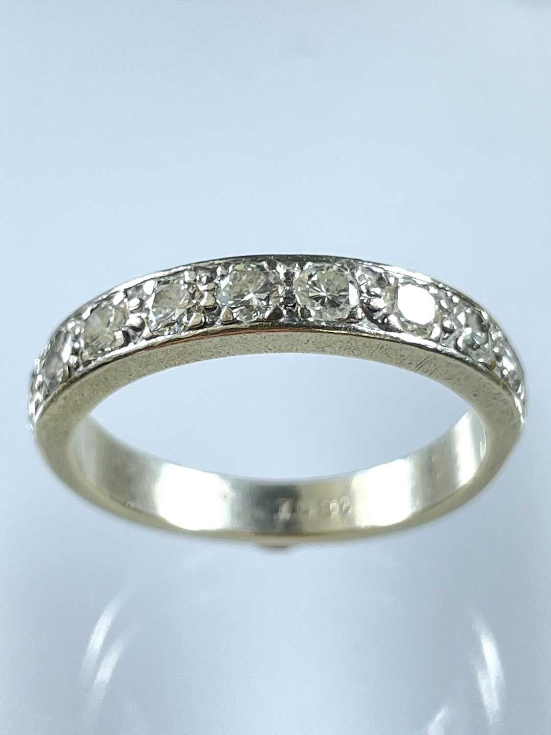 An 18ct white gold diamond set nine stone half eternity ring.