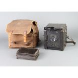 A The Salex Reflex camera together with 11 metal plate carriers contained in a fabric case