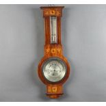 An Edwardian aneroid barometer and thermometer with silvered dial contained in n inlaid mahogany