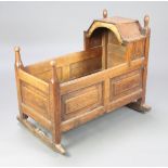 A 17th/18th Century style oak and elm rocking cradle of panelled construction 88cm h x 98cm w x 69cm