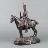 A 20th Century bronze figure of a mounted Napoleonic cavalryman raised on an oval black stepped