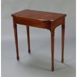 An Edwardian Chippendale style mahogany bow front card table raised on square tapered supports,