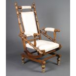 A 19th Century oak American rocking armchair with turned decoration, upholstered seat and back 114cm