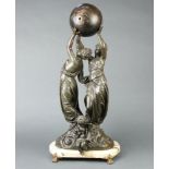 A 19th Century French spelter timepiece in the form of a globe being supported by 2 ladies beneath a