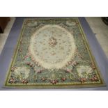 A green and floral patterned machine made carpet 260cm x 275cm Some light stains in places