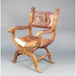 A Victorian carved oak Italian style show frame armchair with carved lion decoration, the seat and