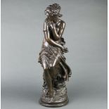 After Mathurin Moreau, a bronzed figure of a seated lady 62cm h x 18cm diam.