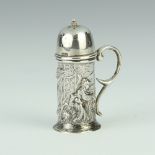 An Edwardian repousse silver miniature novelty pepperette in the form of a stein decorated with