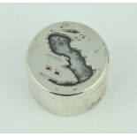 A silver circular pill box the lid decorated with an island 44.2 grams, 4cm, London 1976