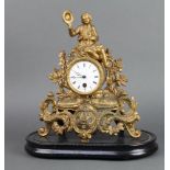 A 19th Century timepiece with enamelled dial and Roman numerals contained a gilt painted spelter