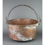 A large copper pot with polished steel handle 23cm h x 51cm diam.