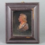 A 19th Century 2 colour wax work portrait bust of a gentleman marked Soke 11cm x 9cm The bust is