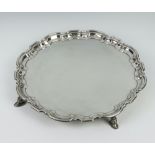 A Georgian style silver salver with Chippendale border raised on scroll feet Sheffield 1968, 30cm,