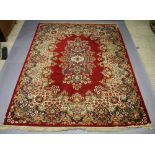 A red and gold ground Wilton Persian style carpet with central medallion 454cm x 366cm w Slight wear