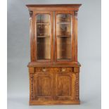 A Victorian mahogany display cabinet on cabinet, the upper section with moulded cornice, fitted