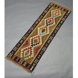 A white, green and turquoise black ground Maimana Kilim runner with all over geometric design