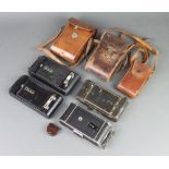 A Voigtlander folding camera, a Kodak vest pocket folding camera in leather case, a Kodak no.120