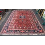 A red and blue ground Northwest Persian carpet with central medallion within a 5 row border 636cm