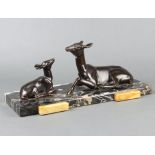 An Art Deco spelter figure group of a seated deer and faun, raised on a 2 colour marble base 16cm