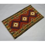 A black, brown and red ground Maimana Kilim with all over geometric designs 139cm x 79cm