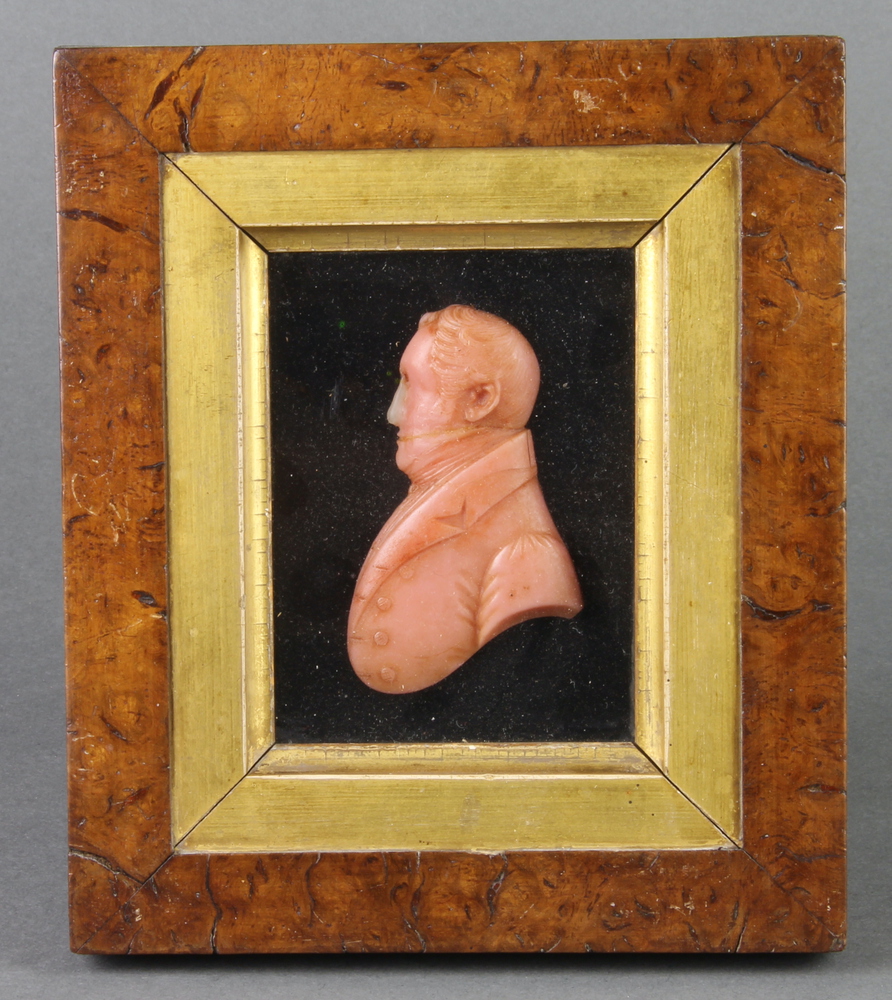 A 19th Century wax portrait bust of a gentleman wearing a frock coat 9cm x 7cm contained in a walnut