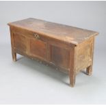 A 17th/18th Century oak coffer of panelled construction, fitted a candle box 55cm h x 114cm w x 46cm