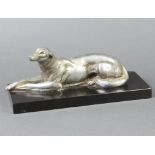 An Art Deco French spelter figure of a reclining Afghan hound raised on a black marble base 13cm h x