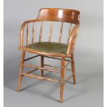 A 19th Century elm tub back chair with bobbin turned decoration, raised on turned supports and