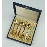 A set of 6 silver gilt and enamelled coffee spoons cased, 70 grams, 9cm