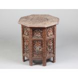 A 19th Century octagonal pierced and carved Indian hardwood occasional table, raised on a folding