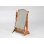 An arched plate dressing table mirror contained in a mahogany swing frame 53cm h x 33cm w x 23cm d