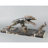After Limousu, an Art Deco spelter figure group of a leaping gazelle and faun, raised on a veined