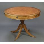 A Georgian style oval mahogany pedestal extending dining/boardroom table with inset tooled leather