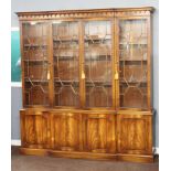A Chippendale style mahogany breakfront display cabinet on cabinet, the upper section with moulded
