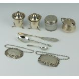 A silver butter knife, 3 condiments, 2 spirit labels, 2 spoons and a mounted box, weighable silver