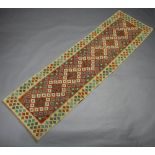 A yellow and orange ground Chobi Kilim runner with all over geometric design 299cm x 60cm