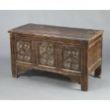 A 17th/18th Century oak coffer with hinged lid and carved panels to the front 71cm h x 124cm w x