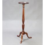 An Edwardian Chippendale style circular mahogany torchere, raised on a turned and fluted column with