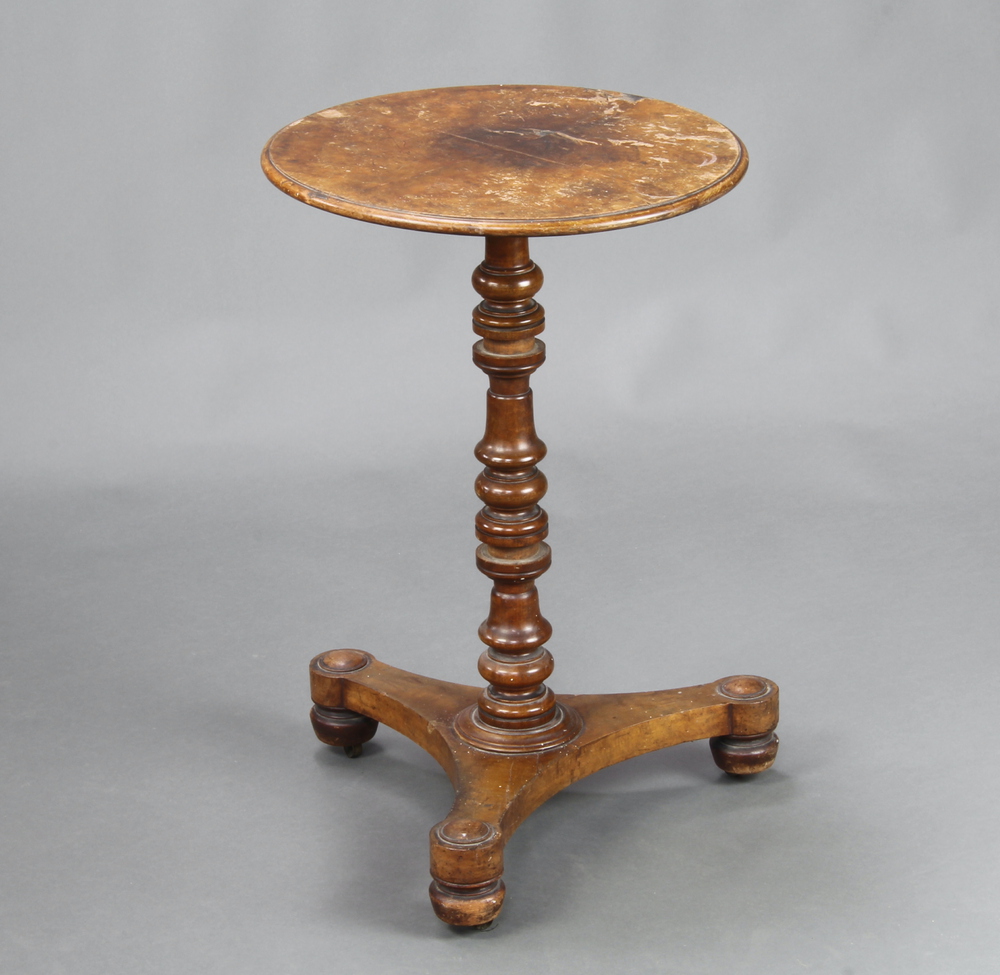 A William IV circular walnut quarter veneered wine table, raised on a turned column, triform base,