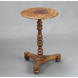 A William IV circular walnut quarter veneered wine table, raised on a turned column, triform base,
