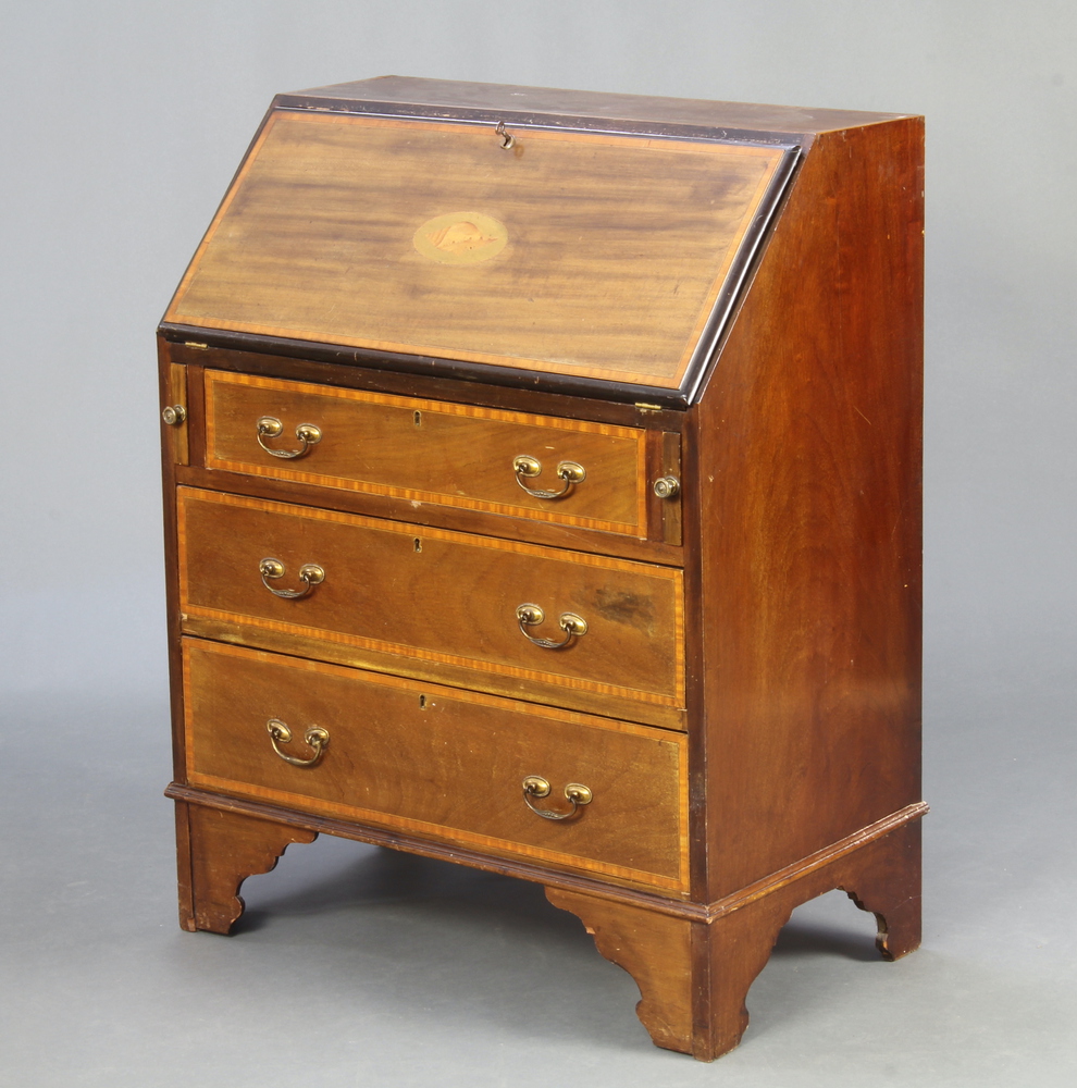 An Edwardian inlaid mahogany bureau, the fall front revealing a fitted interior above 3 drawers,