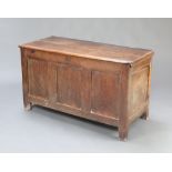 A 17th/18th Century oak coffer of panelled construction and hinged lid, the interior fitted a candle