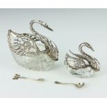 A silver mounted cut glass table salt in the form of a swan 10cm, ditto 7cm and 2 spoons