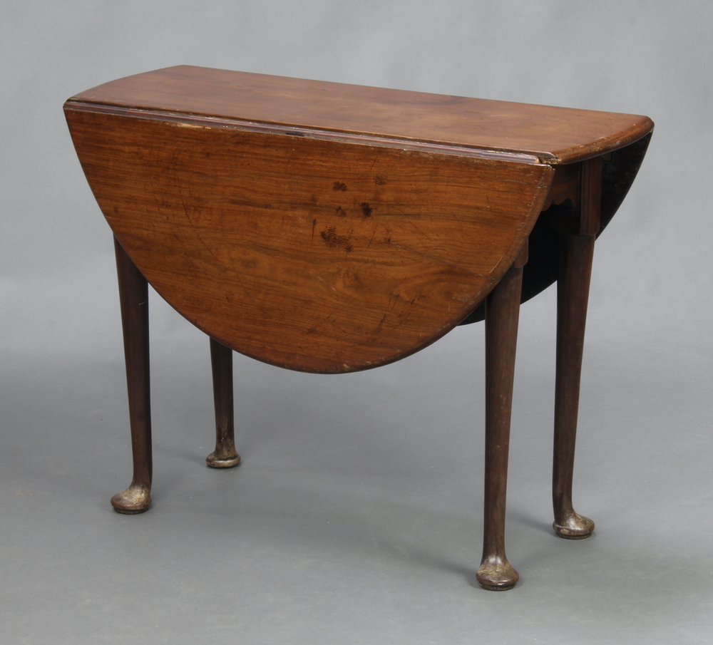 A Georgian mahogany oval drop flap tea table, raised on club supports 68cm h x 90cm w x 35cm when