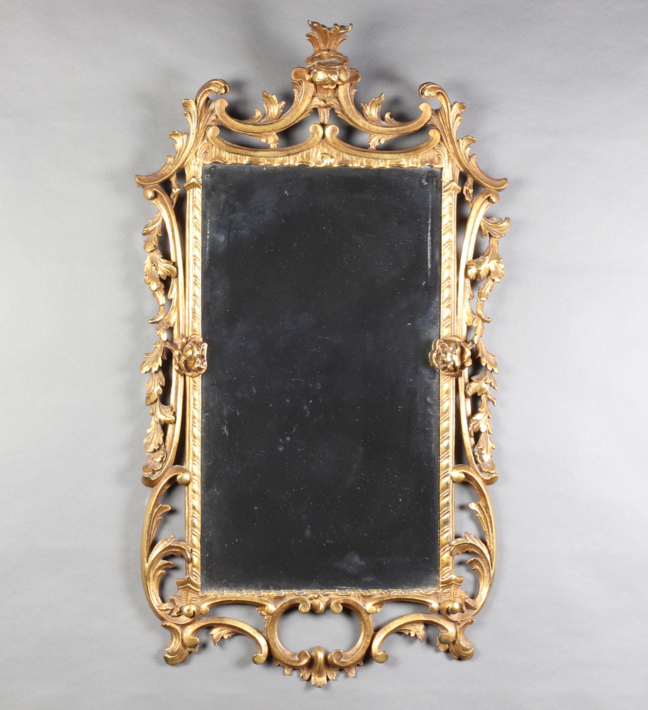 A Rococo style rectangular plate wall mirror contained in a carved gilt wood frame 92cm x 50cm