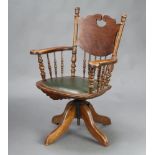 A 19th Century American style tub back revolving office chair with spindle decoration 90cm h x