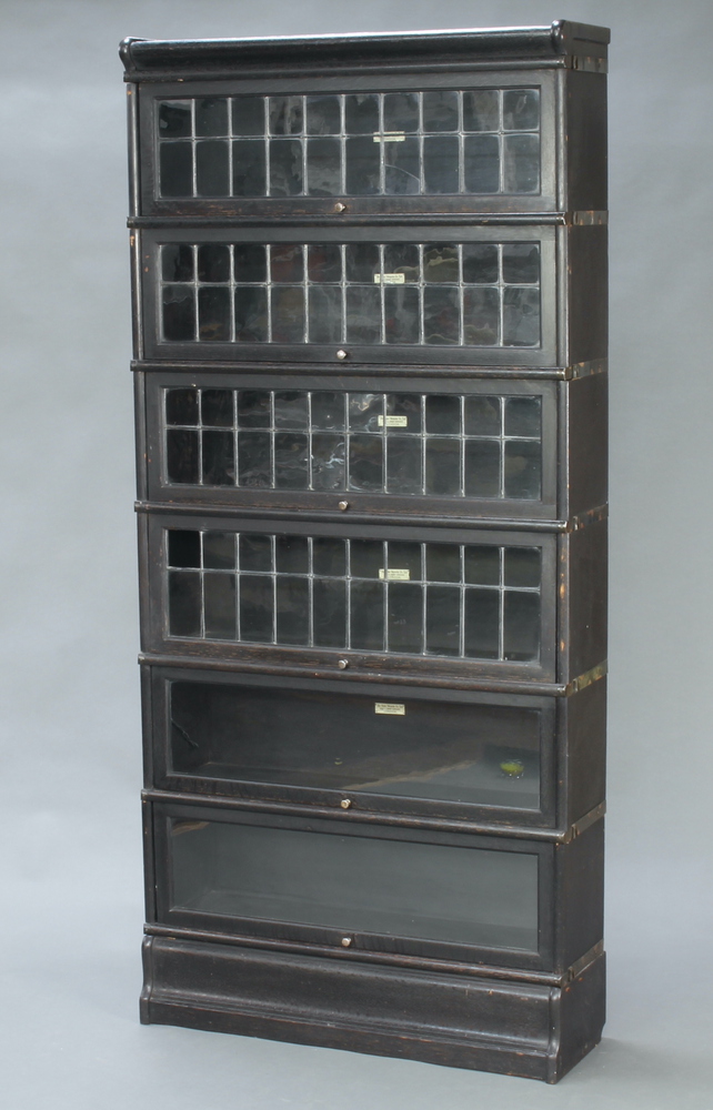 An ebonised oak 6 tier Globe Wernicke bookcase enclosed by lead glazed panelled doors 188cm h x 86cm