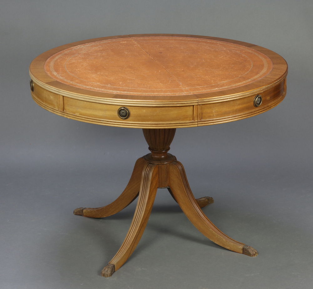 A Georgian style oval mahogany pedestal extending dining/boardroom table with inset tooled leather