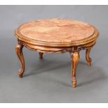 A circular walnut coffee table with inset ink veined marble top, raised on cabriole supports 43cm